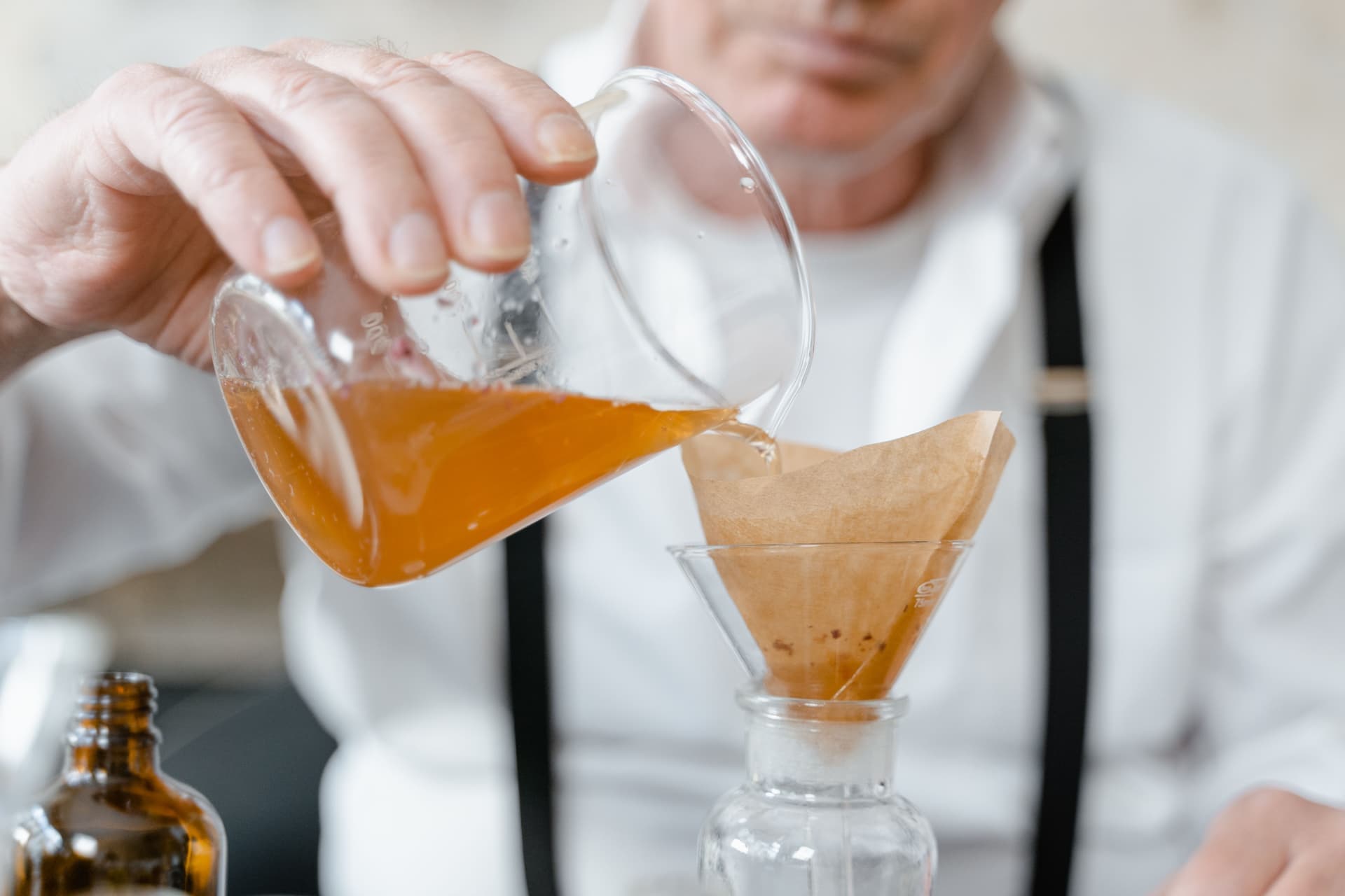 Liquid being poured through a glass funnel