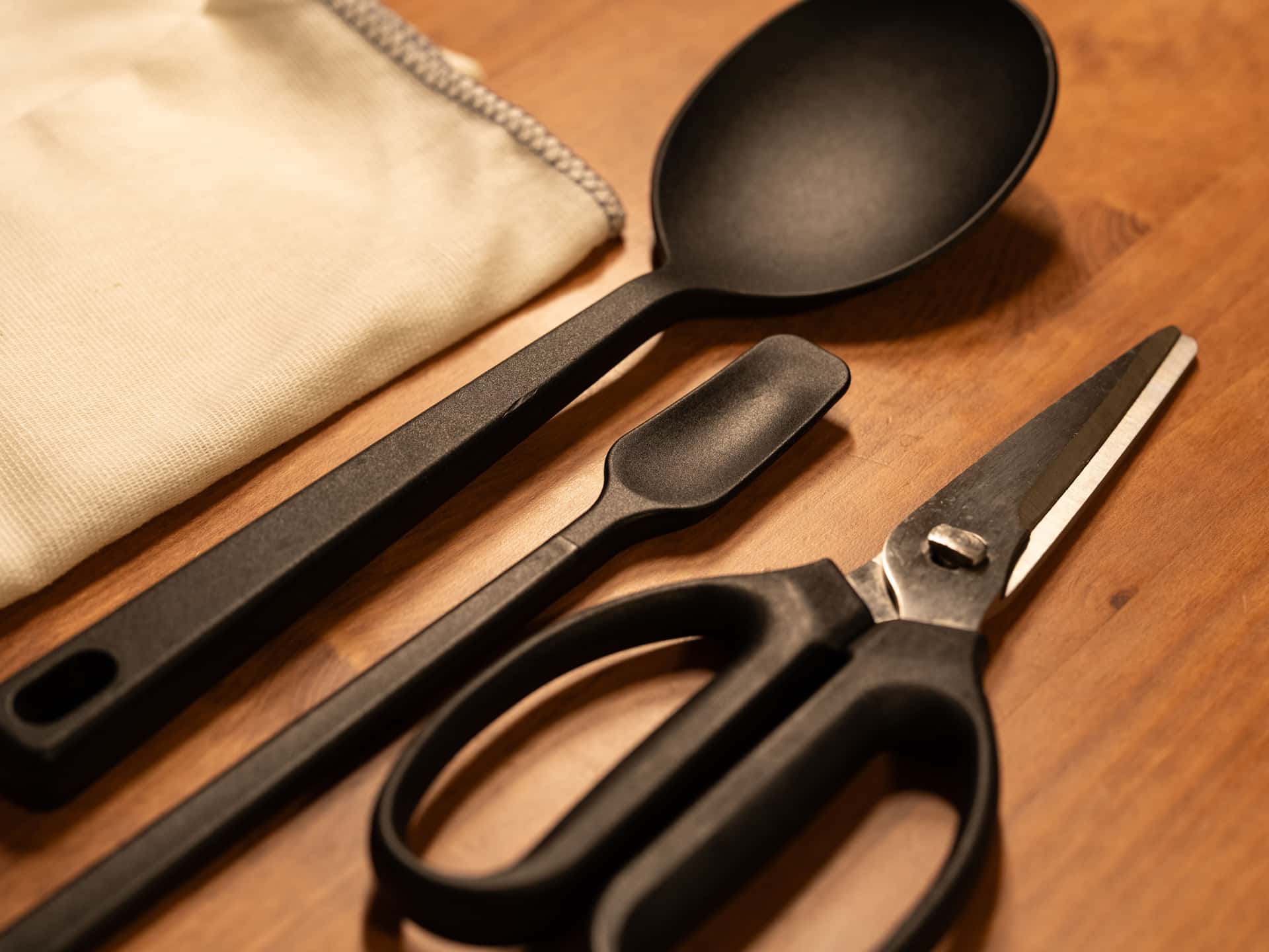 Kitchen utensils arranged on a wooden surface