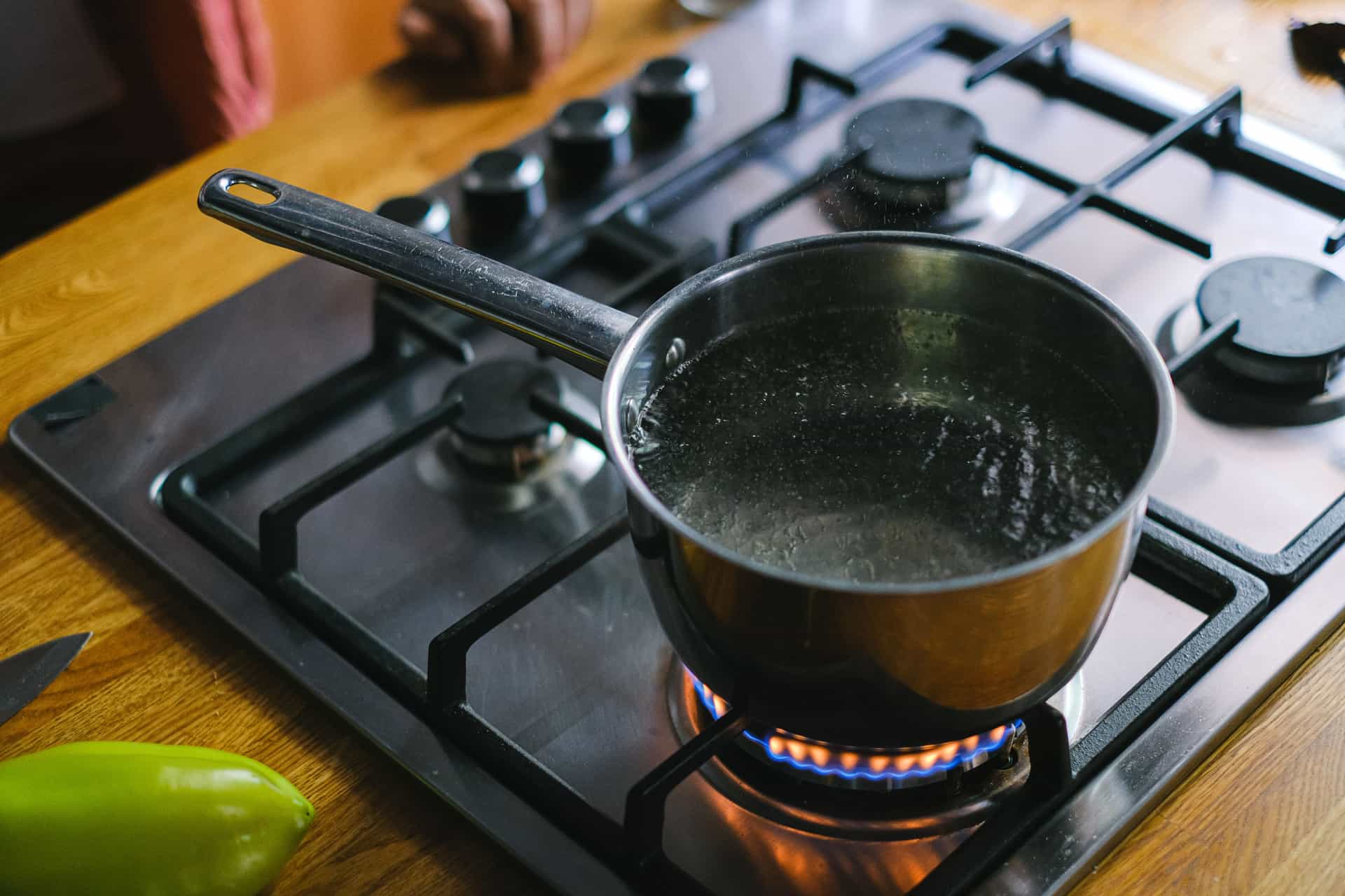 Water boiling in a large pot on a stove burner