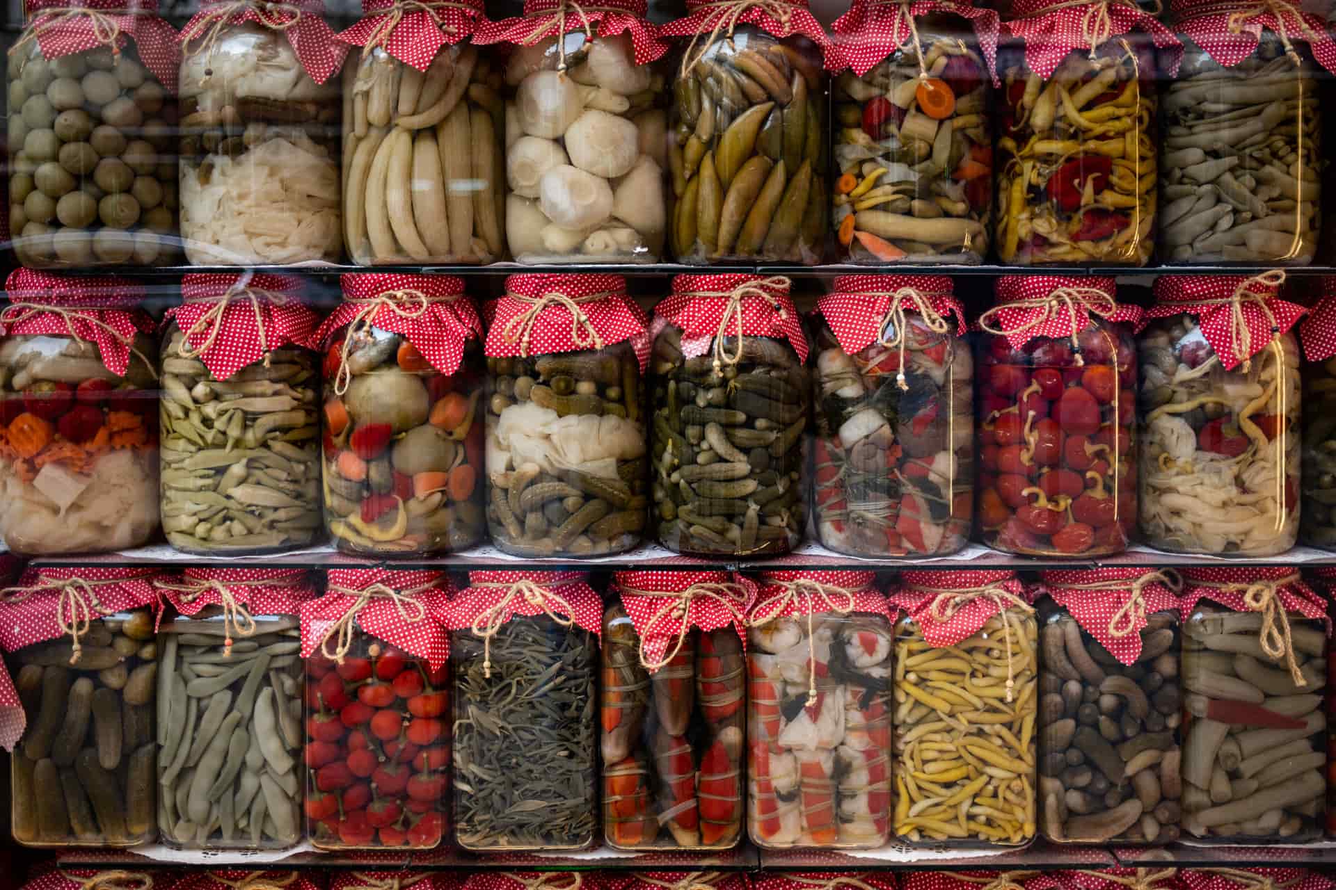 Jars of seasoned preserved food on a shelf